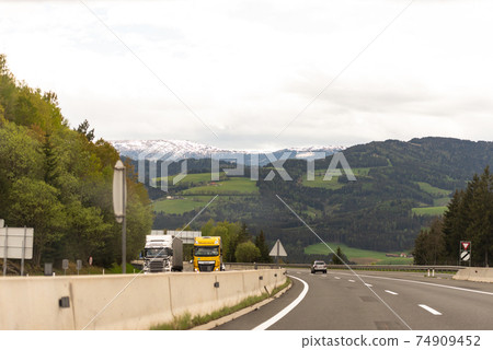 Roads Of Austria. Austrian highway with beautiful views. Photo from the car. Roads Of Austria. Austrian highway with beautiful views. Photo from the car. 74909452