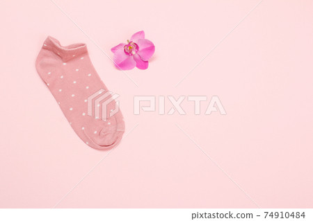 One woman sock on a pink background. One woman sock on a pink background. 74910484