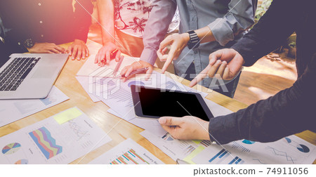 Start up business. people meeting point to discuss the graph up and down of the economy and work on tablet. 74911056