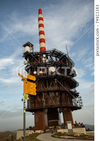 Chasseral, Switzerland - November 7th 2020: Tower and hiking signs on the top 74911163