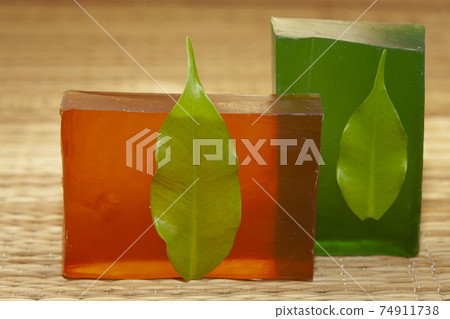 bar of natural handmade soap from indian natural ingredients with green leaf. bar of natural handmade soap from indian natural ingredients with green leaf. 74911738