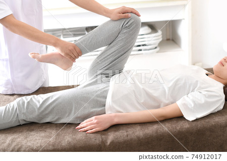 A woman receiving a massage during chiropractic pelvic correction 74912017