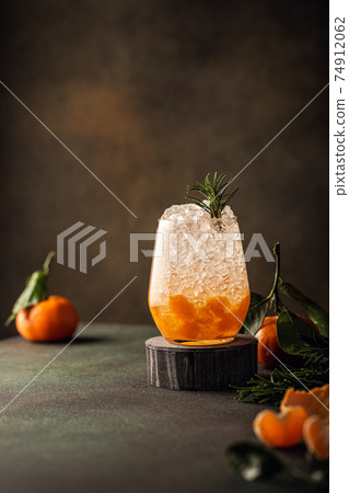 Fresh cocktail with crushed ice, rosemary and tangerines Fresh cocktail with crushed ice, rosemary and tangerines 74912062