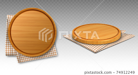 Wooden pizza and cutting boards on kitchen towel Wooden pizza and cutting boards on kitchen towel 74912249