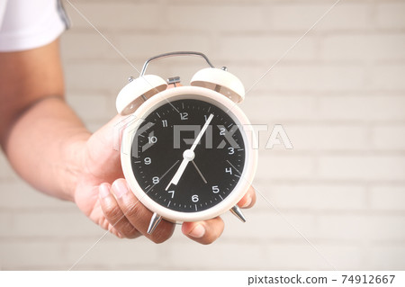 person hand holding alarm clock white background , person hand holding alarm clock white background , 74912667