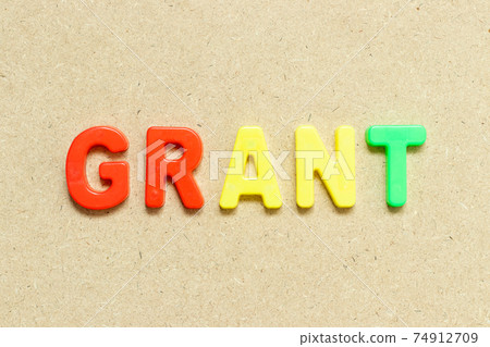 Color alphabet letter with word grant on wood background Color alphabet letter with word grant on wood background 74912709
