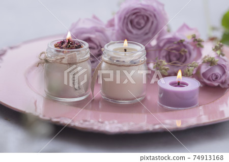 Purple roses and candles 74913168