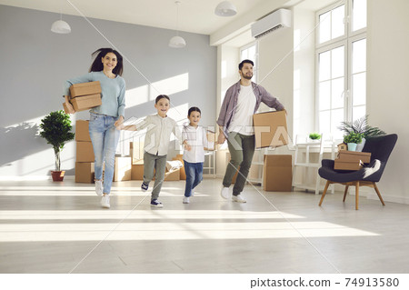 Happy excited young family with little children entering their new house or apartment Happy excited young family with little children entering their new house or apartment 74913580