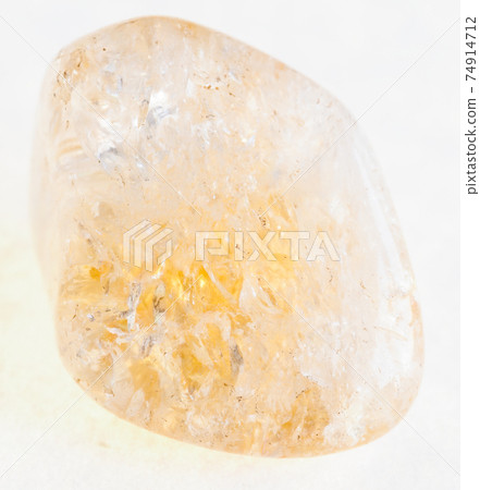 tumbled Citrine (yellow quartz) gemstone on white 74914712