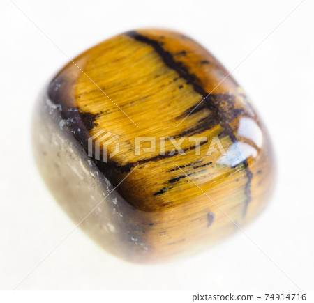 polished tiger's eye (tiger-eye) gem on white 74914716