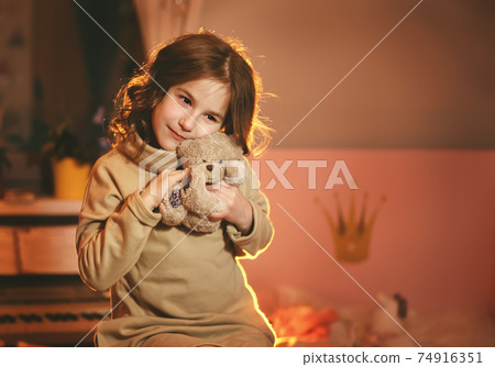 Cute girl with teddy bear in her room 74916351