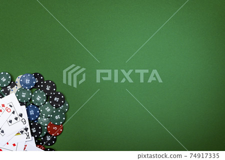 Cards and poker chips on a green background Cards and poker chips on a green background 74917335