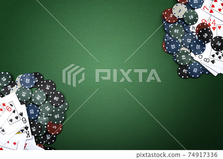 Cards and poker chips on a green background Cards and poker chips on a green background 74917336