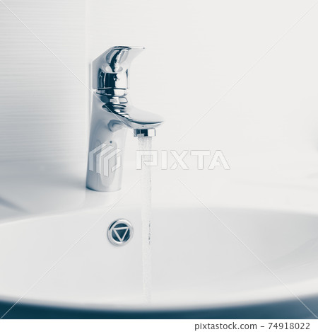 faucet and wash sink with flowing water 74918022