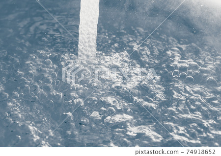 water stream with bubbles, closeup view 74918652