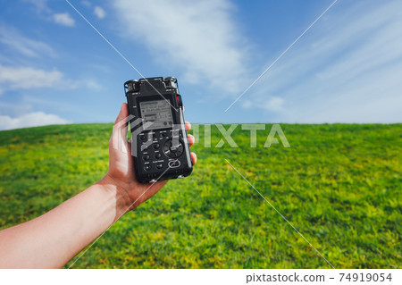 portable audio recorder in hand field recording ambient sounds of nature portable audio recorder in hand field recording ambient sounds of nature 74919054