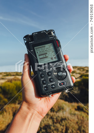 portable audio recorder in hand field recording ambient sounds of nature 74919068