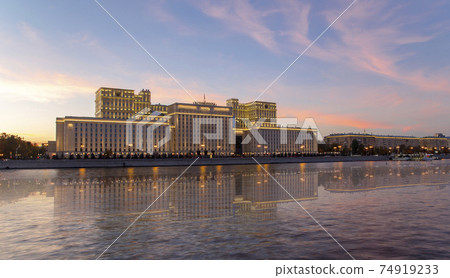 Main Building of the Ministry of Defence of the Russian Federation (Minoboron), at night-- is the governing body of the Russian Armed Forces and Moskva River. Moscow, Russia 74919233
