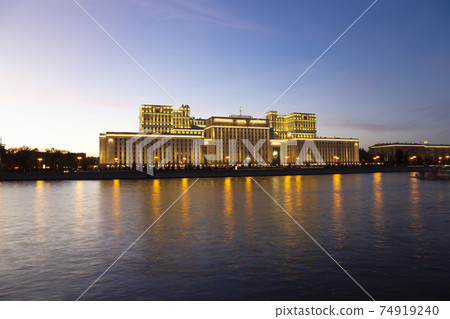 Main Building of the Ministry of Defence of the Russian Federation (Minoboron), at night-- is the governing body of the Russian Armed Forces and Moskva River. Moscow, Russia 74919240