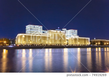Main Building of the Ministry of Defence of the Russian Federation (Minoboron), at night-- is the governing body of the Russian Armed Forces and Moskva River. Moscow, Russia 74919269