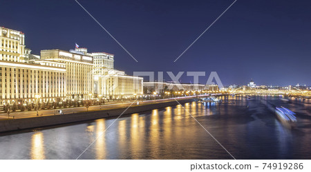 Main Building of the Ministry of Defence of the Russian Federation (Minoboron), at night-- is the governing body of the Russian Armed Forces and Moskva River. Moscow, Russia 74919286