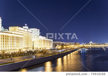 Main Building of the Ministry of Defence of the Russian Federation (Minoboron), at night-- is the governing body of the Russian Armed Forces and Moskva River. Moscow, Russia 74919288