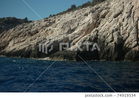 Sandstone rock formation at Mediterranean sea coast. 74919334