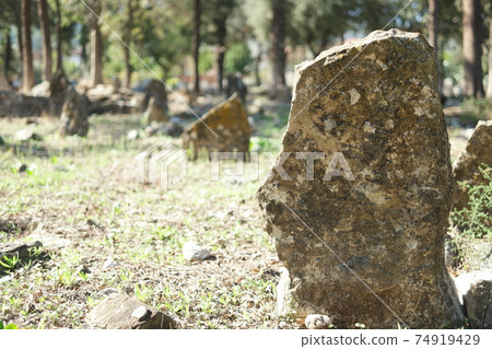 Old weathered tombstone on graveyard. Old weathered tombstone on graveyard. 74919429