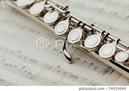transverse flute on music sheet transverse flute on music sheet 74919840