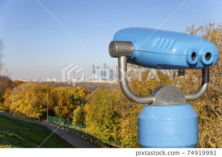 Touristic telescope viewer (binoculars) and view of central Moscow from Sparrow Hills or Vorobyovy Gory observation (viewing) platform-- is on a steep bank 85 m above the Moskva river, or 200 m above Touristic telescope viewer (binoculars) and view of central Moscow from Sparrow Hills or Vorobyovy Gory observation (viewing) platform-- is on a steep bank 85 m above the Moskva river, or 200 m above 74919991