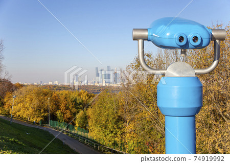 Touristic telescope viewer (binoculars) and view of central Moscow from Sparrow Hills or Vorobyovy Gory observation (viewing) platform-- is on a steep bank 85 m above the Moskva river, or 200 m above Touristic telescope viewer (binoculars) and view of central Moscow from Sparrow Hills or Vorobyovy Gory observation (viewing) platform-- is on a steep bank 85 m above the Moskva river, or 200 m above 74919992