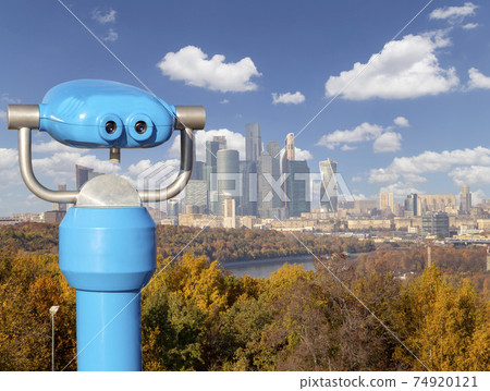 Touristic telescope viewer (binoculars) and view of central Moscow from Sparrow Hills or Vorobyovy Gory observation (viewing) platform 74920121