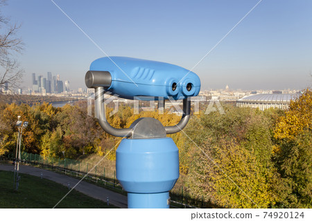 Touristic telescope viewer (binoculars) and view of central Moscow from Sparrow Hills or Vorobyovy Gory observation (viewing) platform 74920124