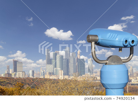 Touristic telescope viewer (binoculars) and view of central Moscow from Sparrow Hills or Vorobyovy Gory observation (viewing) platform 74920134