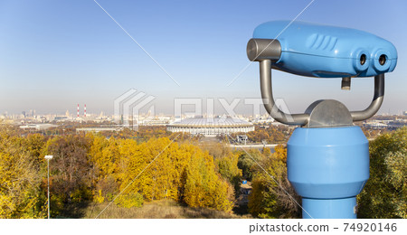 Touristic telescope viewer (binoculars) and view of central Moscow from Sparrow Hills or Vorobyovy Gory observation (viewing) platform 74920146