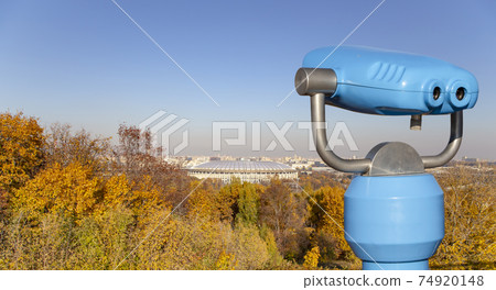 Touristic telescope viewer (binoculars) and view of central Moscow from Sparrow Hills or Vorobyovy Gory observation (viewing) platform 74920148