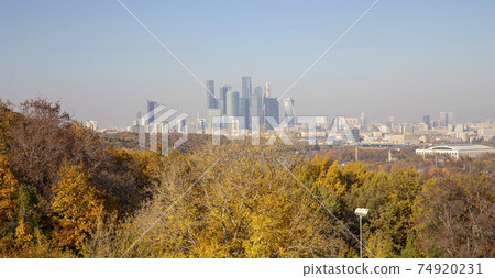 View of the city and the complex of skyscrapers Moscow city from Sparrow Hills or Vorobyovy Gory observation (viewing) platform-- is on a steep bank 85 m above the Moskva river, or 200 m above sea 74920231