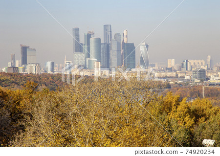 View of the city and the complex of skyscrapers Moscow city from Sparrow Hills or Vorobyovy Gory observation (viewing) platform-- is on a steep bank 85 m above the Moskva river, or 200 m above sea View of the city and the complex of skyscrapers Moscow city from Sparrow Hills or Vorobyovy Gory observation (viewing) platform-- is on a steep bank 85 m above the Moskva river, or 200 m above sea 74920234