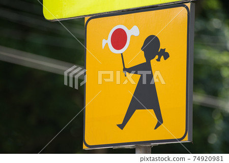 Traffic sign Attention children in Poland. Girl with candy. Close up. Traffic sign Attention children in Poland. Girl with candy. Close up. 74920981