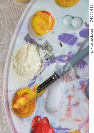 Artist's palette, top view. Mixing paints, brush. Texture, background Artist's palette, top view. Mixing paints, brush. Texture, background 74921418