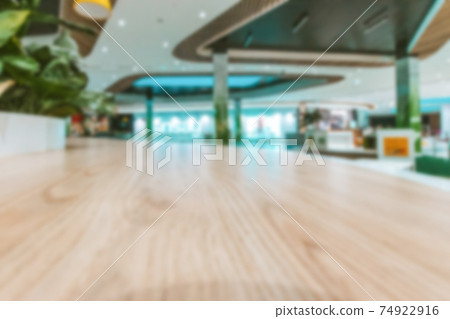 Shopping mall interior blurred background. People shopping in modern commercial mall center. Interior of retail centre store in soft focus. Image for background use. Shopping mall interior blurred background. People shopping in modern commercial mall center. Interior of retail centre store in soft focus. Image for background use. 74922916