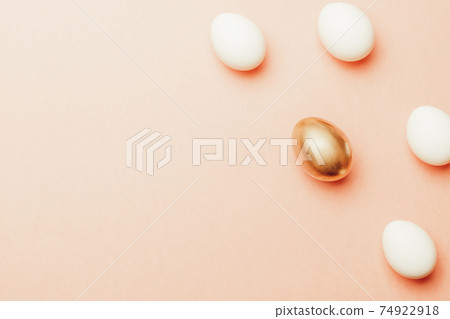 Easter card. Golden, white colour egg on pastel pink background in Happy Easter decoration. Flat lay, top view with copy space. Easter card. Golden, white colour egg on pastel pink background in Happy Easter decoration. Flat lay, top view with copy space. 74922918