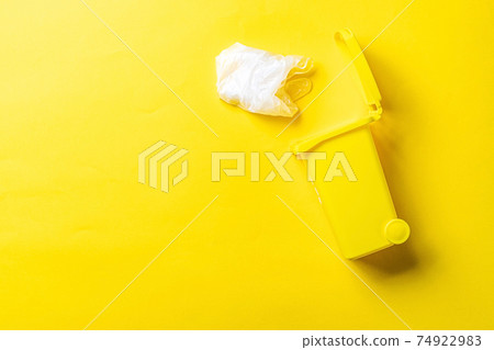 Trash recycle. Bin container for disposal garbage waste and save environment. Yellow dustbin for recycle plastic trash isolated on yellow background. Trash recycle. Bin container for disposal garbage waste and save environment. Yellow dustbin for recycle plastic trash isolated on yellow background. 74922983