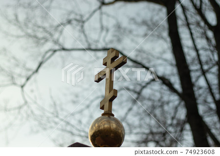 Orthodox cross on a gloomy sky background. Religion concept, faith problem 74923608