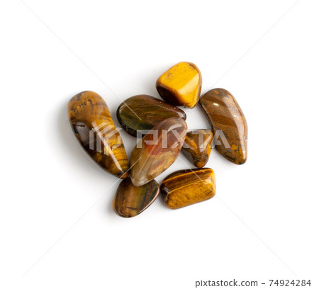 Tiger eye pebbles isolated, brown polished quartz stones 74924284