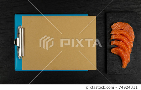 Slices of Raw Salmon Fillet on Black Background Mockup Top View Slices of Raw Salmon Fillet on Black Background Mockup Top View 74924311