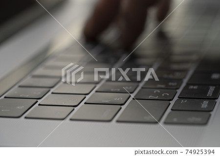 Male hands typing on keyboard on laptop, fingers pressing keyboard, personal computer, blind Male hands typing on keyboard on laptop, fingers pressing keyboard, personal computer, blind 74925394