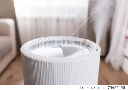 Steam from modern air humidifier, aroma oil diffuser at home. Improving the comfort of living in a house, Improving the well-being. Ultrasonic steam technology. 74926466