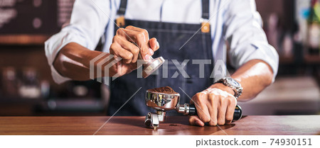 Banner of Asian Barista tamping the portafilter and preparing cup of coffee, espresso with latte or cappuccino for customer order in coffee shop,Small business owner and startup in coffee shop concept 74930151