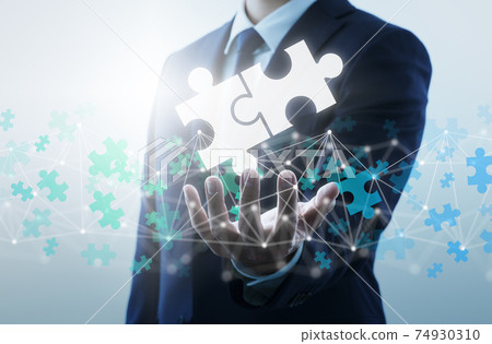 Find a solution from the internet. A man who connects two puzzle pieces. Find a solution from the internet. A man who connects two puzzle pieces. 74930310